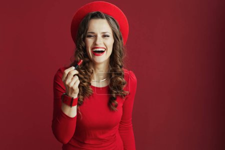 Photo for Happy Valentine. happy stylish female in red dress and beret on red background with red lipstick. - Royalty Free Image
