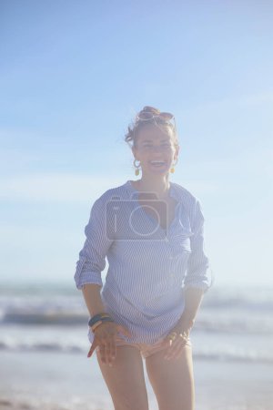 Photo for Happy stylish middle aged woman at the beach having fun time. - Royalty Free Image