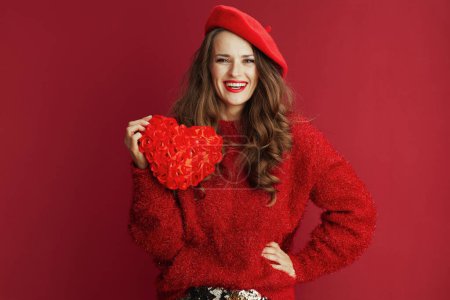 Photo for Happy Valentine. smiling elegant woman in red sweater and beret with red heart and long wavy hair. - Royalty Free Image