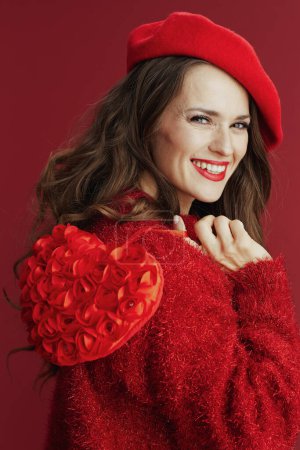 Foto de Happy Valentine. happy elegant middle aged woman in red sweater and beret with red heart. - Imagen libre de derechos