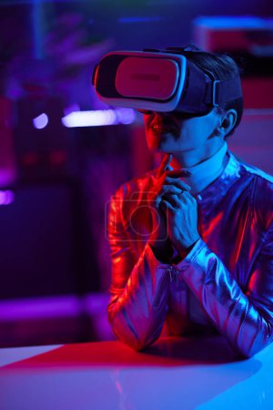 Photo for Neon metaverse futuristic concept. happy trendy female in vr headset designing virtual reality in modern office. - Royalty Free Image