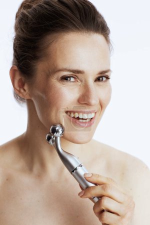 Photo for Portrait of smiling modern woman with massager against white background. - Royalty Free Image