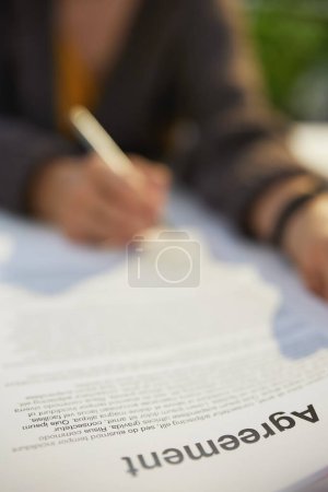 Photo for Woman reading agreement document. - Royalty Free Image