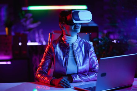 Photo for Neon metaverse futuristic concept. trendy woman in vr headset in modern office. - Royalty Free Image
