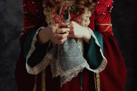 Photo for Closeup on medieval queen in red dress with handkerchief on dark gray background. - Royalty Free Image