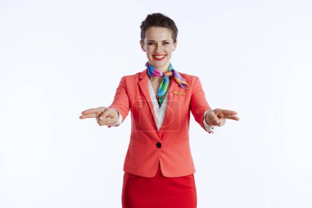 Photo for Smiling elegant female stewardess isolated on white background in uniform making hand gesture. - Royalty Free Image