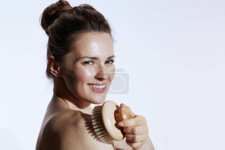 Téléchargez les photos : Happy modern 40 years old woman with massager isolated on white. - en image libre de droit