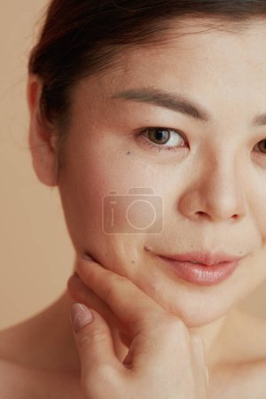 Photo for Closeup on woman looking in camera on beige background. - Royalty Free Image