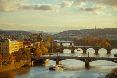 Photo for Landscape with Vltava river, Karlov most and boat in the evening in autumn in Prague, Czech Republic. - Royalty Free Image