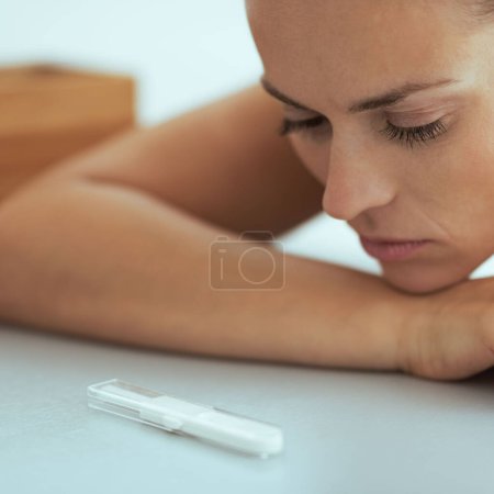 Photo for Young woman looking on pregnancy test - Royalty Free Image