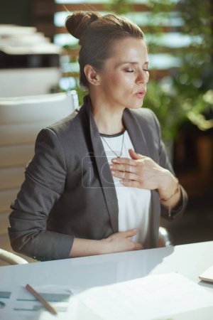 Photo for Sustainable workplace. relaxed modern small business owner woman in modern green office doing breathing exercises. - Royalty Free Image