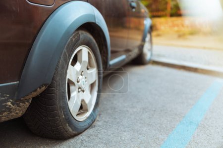 Photo for Car accident. Closeup on car with flat tire in the city. - Royalty Free Image