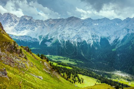 Photo for Summer time in Dolomites. landscape with mountains, hills, clouds and trees. - Royalty Free Image