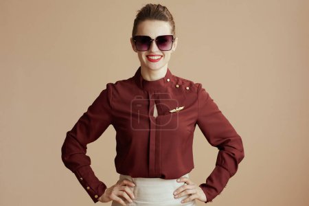 Photo for Happy modern stewardess woman on beige background with sunglasses. - Royalty Free Image