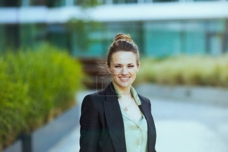 Photo for Portrait of happy modern female employee in business district in black jacket. - Royalty Free Image