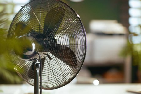Photo for Summer time. metal fan in modern green office. - Royalty Free Image