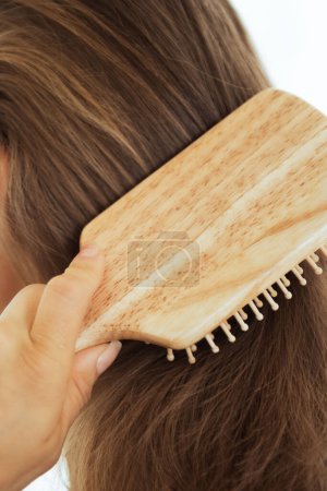 Photo for Closeup on young woman combing hair - Royalty Free Image