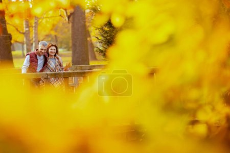 Photo for Hello autumn. smiling stylish couple in the park walking on the bridge. - Royalty Free Image