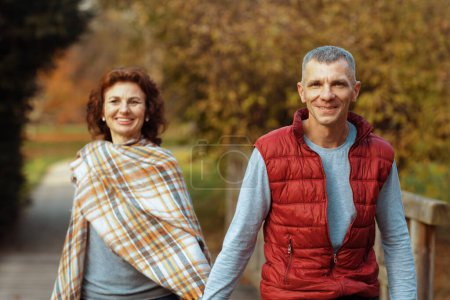 Photo for Hello autumn. smiling romantic family in the park walking. - Royalty Free Image