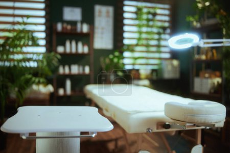 Photo for Healthcare time. massage table and table on wheels in modern spa salon. - Royalty Free Image