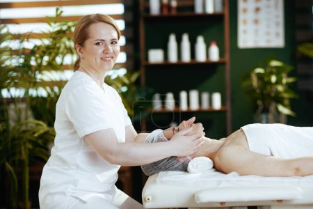 Téléchargez les photos : Temps de santé. massothérapeute médical dans le salon de spa massant le visage des clients sur la table de massage. - en image libre de droit