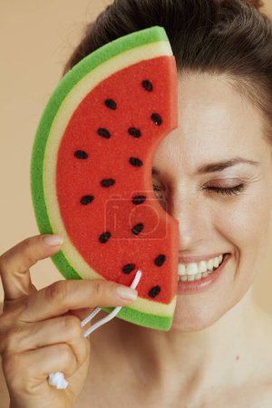 Photo for Happy young woman with watermelon shower sponge. - Royalty Free Image