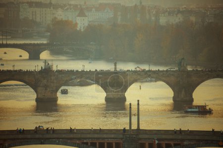 Photo for Landscape with Vltava river, Charles Bridge and boat at sunset in autumn in Prague, Czech Republic. - Royalty Free Image