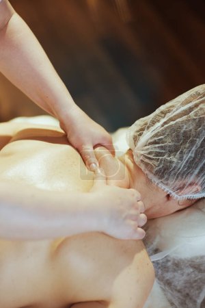 Photo for Healthcare time. Closeup on massage therapist in spa salon massaging clients neck. - Royalty Free Image