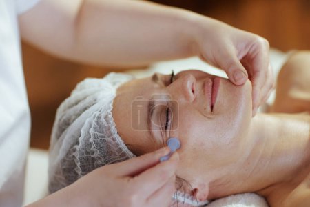 Photo for Healthcare time. massage therapist in spa salon with vacuum therapy cup massaging clients face. - Royalty Free Image