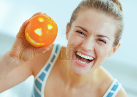 Photo for Happy young woman showing halloween orange - Royalty Free Image