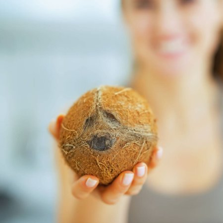 Photo for Closeup on coconut in hand of young woman - Royalty Free Image