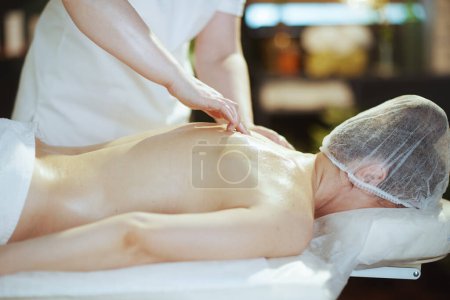 Photo for Healthcare time. massage therapist in spa salon do a therapeutic massage on massage table. - Royalty Free Image