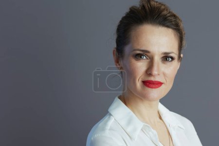 Photo for Elegant woman worker in white blouse against gray background. - Royalty Free Image