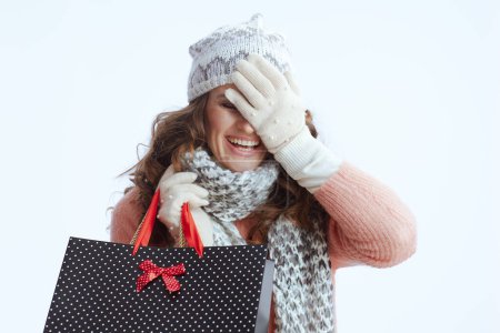 Photo for Hello winter. excited stylish 40 years old woman in sweater, mittens, hat and scarf with shopping bags isolated on white. - Royalty Free Image