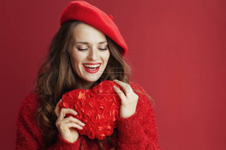 Photo for Happy Valentine. smiling trendy female in red sweater and beret with red heart and long wavy hair. - Royalty Free Image