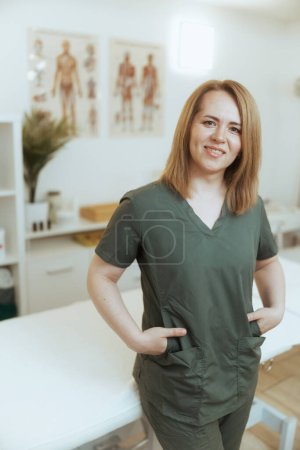 Photo for Healthcare time. smiling massage therapist woman in massage cabinet looking at camera. - Royalty Free Image