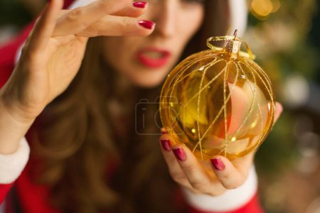 Photo for Christmas time. Closeup on middle aged woman woman witching with in the living room. - Royalty Free Image