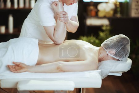 Photo for Healthcare time. massage therapist in spa salon massaging clients back on massage table. - Royalty Free Image