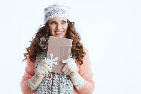 Photo for Hello winter. happy modern woman in sweater, mittens, hat and scarf isolated on white background with snowflake and book. - Royalty Free Image