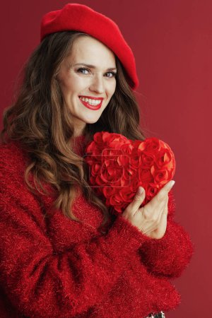 Photo for Happy Valentine. smiling elegant middle aged woman in red sweater and beret with red heart. - Royalty Free Image