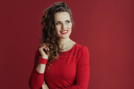 Téléchargez les photos : Joyeux Valentin. élégante femme d'âge moyen avec de longs cheveux ondulés en robe rouge et béret sur fond rouge. - en image libre de droit