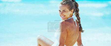 Photo for Smiling young woman at seaside - Royalty Free Image