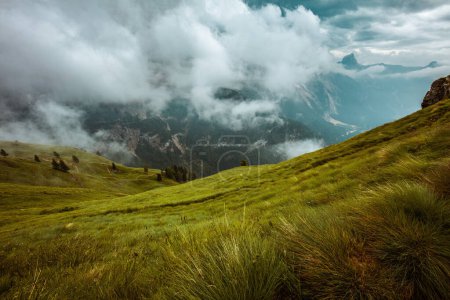 Photo for Summer time in Dolomites. landscape with mountains, hills, clouds, meadow and fog. - Royalty Free Image