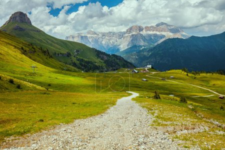 Photo for Summer time in Dolomites. landscape with mountains, hills, clouds, grass and trail. - Royalty Free Image