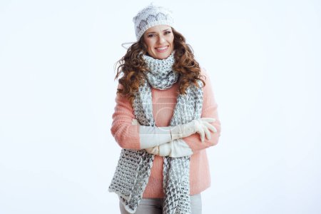 Photo for Hello winter. Portrait of smiling stylish woman in sweater, mittens, hat and scarf against white background. - Royalty Free Image