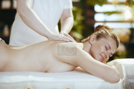 Téléchargez les photos : Temps de santé. massothérapeute dans le salon de spa avec client détendu massant client sur table de massage. - en image libre de droit