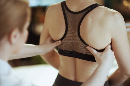 Photo for Healthcare time. Closeup on massage therapist in spa salon checking clients back condition during examination. - Royalty Free Image