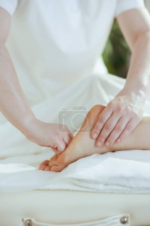 Téléchargez les photos : Temps de santé. Gros plan sur massothérapeute dans l'armoire de massage massant les pieds des clients. - en image libre de droit