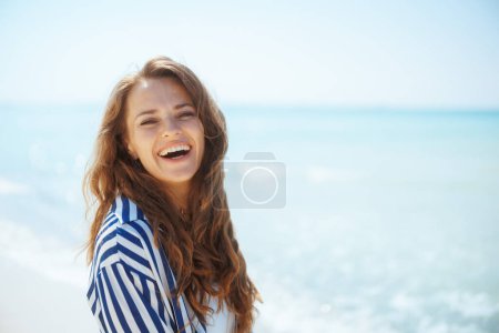 Photo for Happy elegant woman on the ocean shore having fun time. - Royalty Free Image