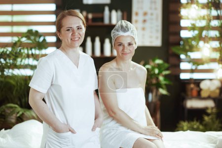 Photo for Healthcare time. medical massage therapist in spa salon with relaxed client. - Royalty Free Image
